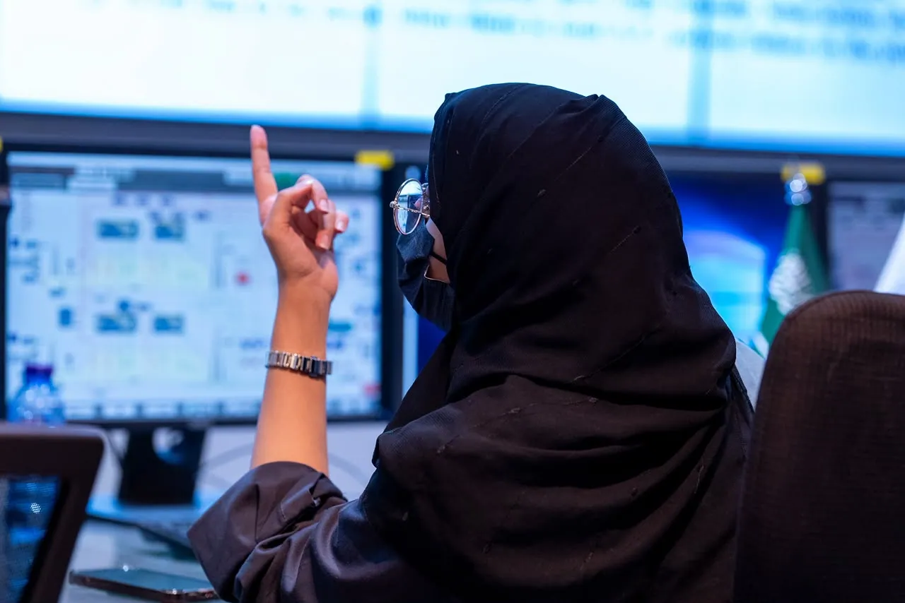 Engineer pointing at a control-room screen